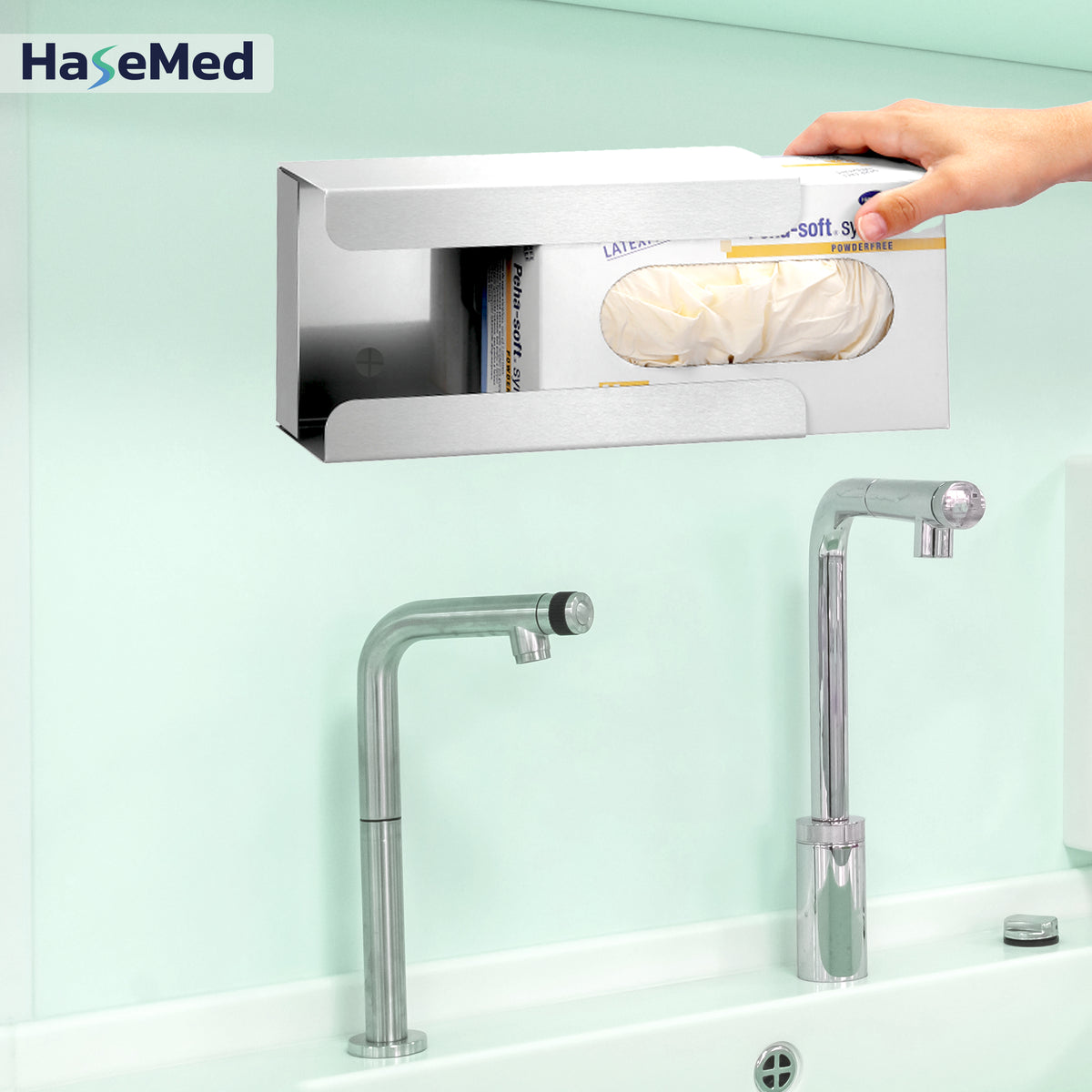Stainless steel HaseMed HAS-30 holder with spring for one glove box, shown during box insertion. One holder supplied. Gloves and boxes not included.